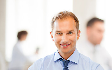 Image showing smiling businessman in office