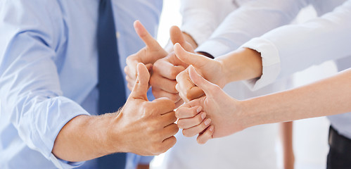 Image showing business team showing thumbs up in office