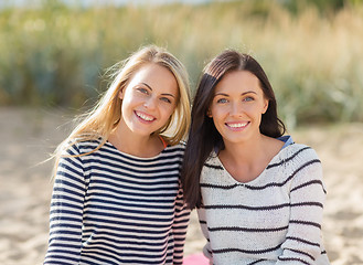 Image showing happy teenage girls or young women on beach