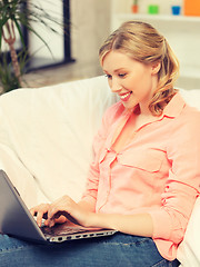 Image showing woman with laptop typing  at home