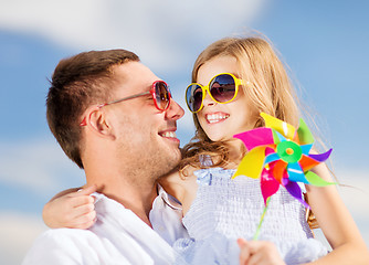 Image showing happy father and child in sunglasses over blue sky