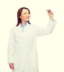 Image showing young female doctor writing something in the air