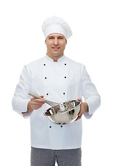 Image showing happy male chef cook whipping something with whisk