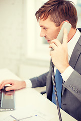 Image showing businessman with laptop computer and phone