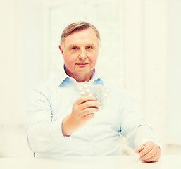 Image showing old man with pack of pills