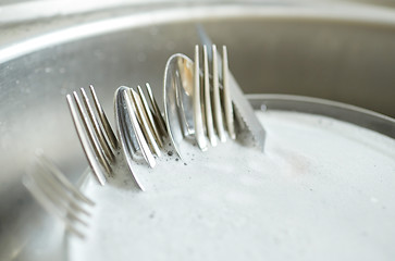 Image showing close up of dirty dishes washing in kitchen sink