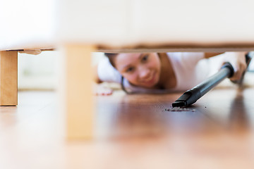 Image showing close up of woman with vacuum cleaner at home