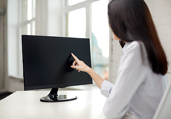 Image showing close up of woman with computer monitor in office