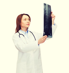 Image showing serious female doctor looking at x-ray