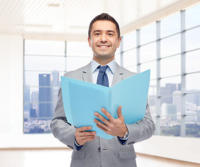 Image showing happy businessman with open folder