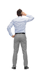 Image showing businessman scratching his head from back