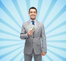 Image showing smiling businessman with american dollar money