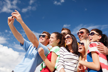 Image showing group of friends taking selfie with cell phone