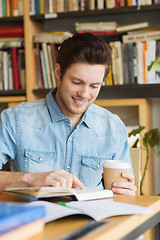 Image showing happy student reading book and drinking coffee