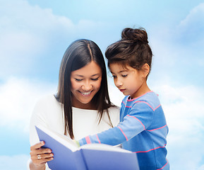 Image showing happy mother and daughter reading book