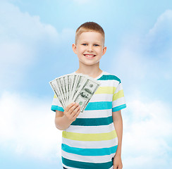 Image showing smiling boy holding dollar cash money in his hand