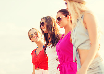 Image showing group of smiling women in sunglasses on beach