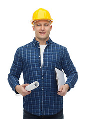 Image showing smiling male builder in helmet with blueprint