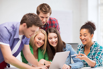 Image showing international students looking at laptop at school