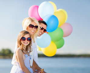 Image showing family with colorful balloons