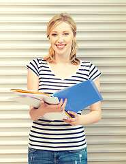 Image showing happy teenage girl with books and folders