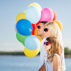 Image showing family with colorful balloons