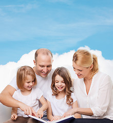 Image showing happy family with book at home