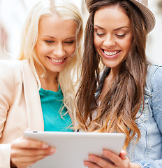 Image showing beautiful girls toursits looking into tablet pc