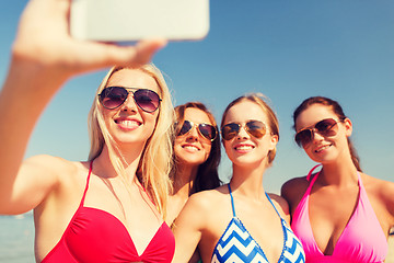 Image showing group of smiling women making selfie on beach