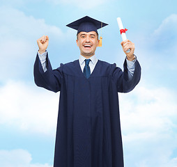 Image showing smiling adult student in mortarboard with diploma