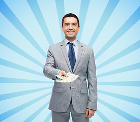 Image showing smiling businessman with american dollar money