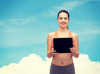 Image showing sporty woman with tablet pc blank screen