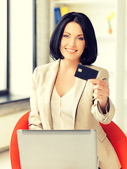 Image showing businesswoman with laptop showing credit card