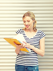 Image showing happy teenage girl with books and folders