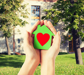 Image showing hands holding green paper house