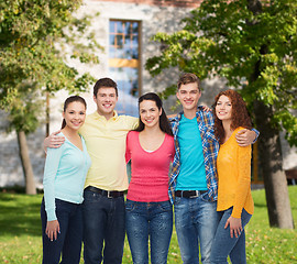 Image showing group of smiling teenagers over campus background