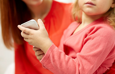 Image showing close up of woman and little girl with smartphone