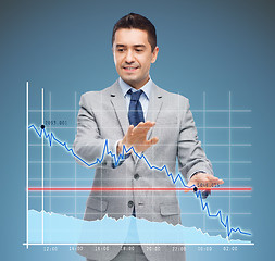 Image showing businessman touching virtual screen with chart