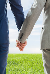 Image showing close up of male gay couple holding hands