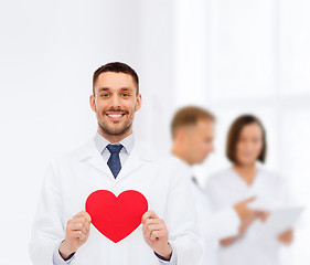 Image showing smiling male doctor with red heart