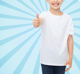 Image showing close up of boy in white t-shirt showing thumbs