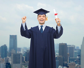 Image showing smiling adult student in mortarboard with diploma