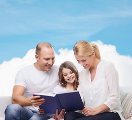 Image showing happy family with book at home