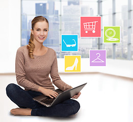 Image showing smiling woman with laptop shopping online at home
