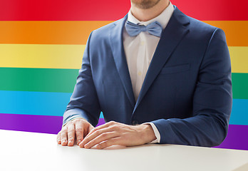 Image showing close up of man in suit and bow-tie at table