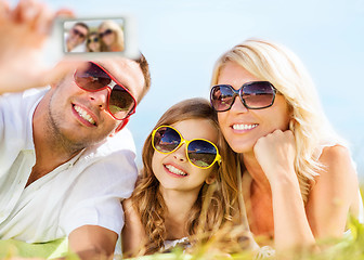 Image showing happy family with camera taking picture