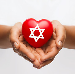 Image showing female hands holding heart with star of david