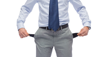 Image showing close up of businessman showing empty pockets