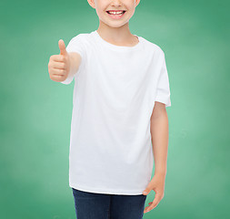 Image showing close up of boy in white t-shirt showing thumbs 