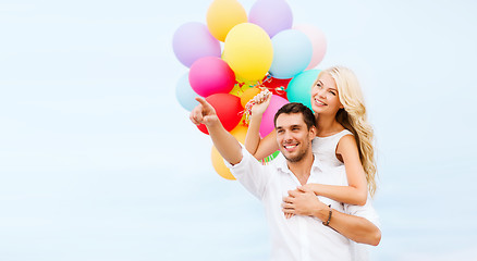 Image showing couple with colorful balloons at sea side